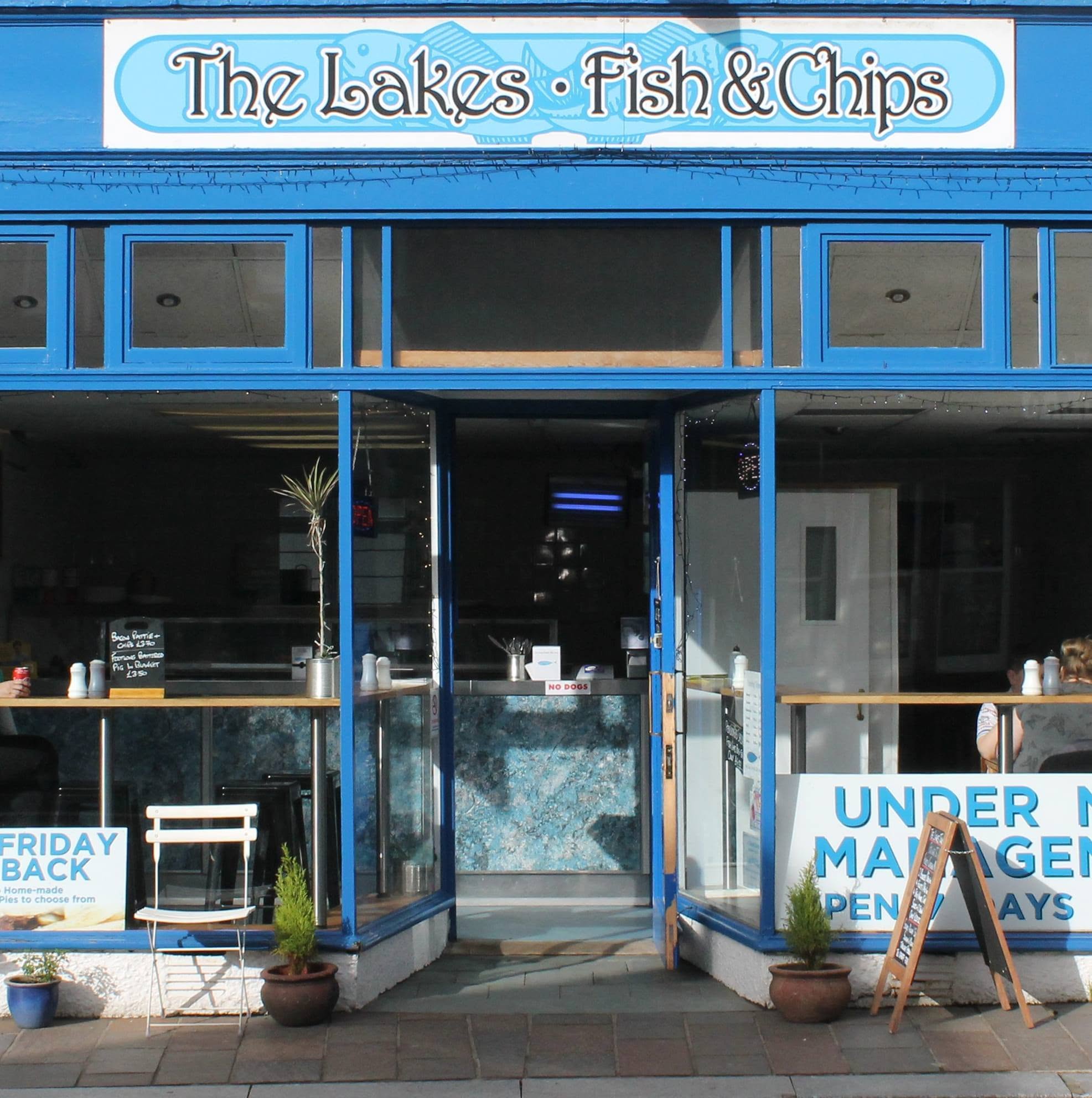 The Lakes Fish and Chips blue storefront, complete sign, open shop doors, threshold and pavement
